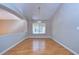 Formal dining room with a modern chandelier and laminate wood flooring at 2529 Clareside Dr, Valrico, FL 33596