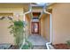 Inviting front entrance with a red door, neutral stucco exterior, and lovely landscaping at 2529 Clareside Dr, Valrico, FL 33596