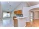 Open kitchen with granite counters, oak cabinets, tile backsplash, and vaulted ceilings at 2529 Clareside Dr, Valrico, FL 33596