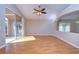 Bright living room with wood floors, fan, sliding glass doors and architectural details at 2529 Clareside Dr, Valrico, FL 33596