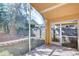 Covered patio with brick floors overlooking landscaped backyard and fence at 2529 Clareside Dr, Valrico, FL 33596