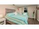 Bedroom with light wood headboard and teal decor at 2713 Apia Pl, Holiday, FL 34691