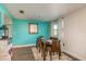 Charming dining area with a teal accent wall and wooden dining table at 2713 Apia Pl, Holiday, FL 34691