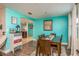 Bright dining room with a teal accent wall, wooden table, and six chairs at 2713 Apia Pl, Holiday, FL 34691