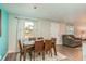 Well-lit dining room, featuring a wooden table and six chairs at 2713 Apia Pl, Holiday, FL 34691