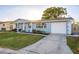 Single story home with a landscaped front yard and attached garage at 2713 Apia Pl, Holiday, FL 34691