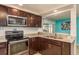 Modern kitchen with stainless steel appliances and granite countertops at 2713 Apia Pl, Holiday, FL 34691