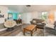 Spacious living room with ample seating and a view into the dining area at 2713 Apia Pl, Holiday, FL 34691