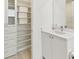 Bathroom with modern vanity, shelving, and linen closet at 2910 W Barcelona St # 1901, Tampa, FL 33629