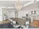 Elegant dining room with a large table and modern chandelier at 2910 W Barcelona St # 1901, Tampa, FL 33629
