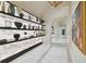 Stunning hallway with backlit shelving and marble floors at 2910 W Barcelona St # 1901, Tampa, FL 33629