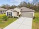 Attractive single-story home with a two-car garage and manicured lawn at 2950 Lytton Hall Dr, Zephyrhills, FL 33540