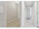 Hallway with tile flooring and neutral-colored walls leading to different rooms at 2950 Lytton Hall Dr, Zephyrhills, FL 33540