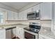 Modern kitchen features granite countertops and stainless steel appliances at 39093 Citadel Cir, Zephyrhills, FL 33542