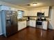 Modern kitchen with white cabinets and stainless steel appliances at 39093 Citadel Cir, Zephyrhills, FL 33542