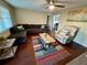 Bright living room with wood floors and L-shaped couch at 39093 Citadel Cir, Zephyrhills, FL 33542