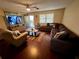 Spacious living room featuring a comfortable sectional sofa at 39093 Citadel Cir, Zephyrhills, FL 33542