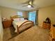 Spacious main bedroom with a king-size bed and access to the pool at 39093 Citadel Cir, Zephyrhills, FL 33542