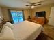Main bedroom with king-size bed and sliding doors to the pool at 39093 Citadel Cir, Zephyrhills, FL 33542