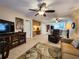 Spacious living room with a view into the kitchen and access to the balcony at 407 Tarpon Pt # 407, Tarpon Springs, FL 34689