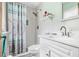 Clean bathroom with a shower/tub combo, white vanity, and tile floors at 5005 Lily Street N Pl, Pinellas Park, FL 33782