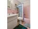 Pink bathroom with a bathtub and shower at 5005 Lily Street N Pl, Pinellas Park, FL 33782
