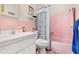 Pink bathroom with bathtub, shower, and vanity at 5005 Lily Street N Pl, Pinellas Park, FL 33782