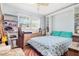 Bedroom with a queen bed and built-in shelves at 5005 Lily Street N Pl, Pinellas Park, FL 33782