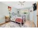 Cozy bedroom with a metal bed frame, wood floors, and a ceiling fan at 5005 Lily Street N Pl, Pinellas Park, FL 33782