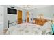Bedroom with a metal bed frame, dresser and wood floors at 5005 Lily Street N Pl, Pinellas Park, FL 33782