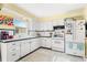 Bright kitchen with white cabinets and appliances at 5005 Lily Street N Pl, Pinellas Park, FL 33782