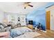 Bright living room with hardwood floors, comfy seating, and a view to the front door at 5005 Lily Street N Pl, Pinellas Park, FL 33782