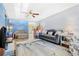 Spacious living room featuring a blue accent wall, comfy seating, and hardwood floors at 5005 Lily Street N Pl, Pinellas Park, FL 33782
