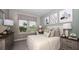 Bright bedroom with a queen-size bed and stylish decor, including a window seat at 5132 Slate Hue Pl, Apollo Beach, FL 33572