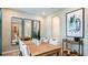 Elegant dining room with wood table and statement art at 5132 Slate Hue Pl, Apollo Beach, FL 33572