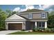 Two-story house with brown garage door and landscaped yard at 5132 Slate Hue Pl, Apollo Beach, FL 33572