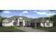 Beautiful two-story home with a three-car garage and landscaped yard at 5325 Lake Toscana Dr, Wimauma, FL 33598