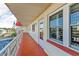 Exterior walkway leading to condo unit with glass doors and storm shutters at 5840 30Th S Ave # 305, Gulfport, FL 33707