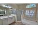 Bathroom with soaking tub, shower, and double vanity at 6013 Catlin Dr, Tampa, FL 33647