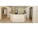 Kitchen with white cabinets, island, and tile flooring at 6013 Catlin Dr, Tampa, FL 33647