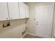 Laundry room with upper cabinets and built-in shelving at 6013 Catlin Dr, Tampa, FL 33647