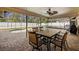 Covered patio with outdoor dining set and view of the pool at 6055 30Th S St, St Petersburg, FL 33712