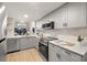 Modern gray kitchen with stainless steel appliances at 6211 Timber Lake Dr # B8, Sarasota, FL 34243