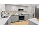 Modern kitchen with gray cabinets and quartz countertops at 6211 Timber Lake Dr # B8, Sarasota, FL 34243