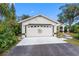 Inviting front yard with a decorative garage door and a well-maintained lawn at 630 Linda Ct, Palm Harbor, FL 34684