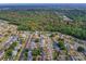 High-angle aerial shot of a residential area surrounded by lush greenery and winding streets at 6321 Staunton Dr, Holiday, FL 34690