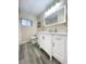 Updated bathroom with a modern vanity, well-lit mirror, and walk-in shower at 6321 Staunton Dr, Holiday, FL 34690