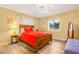 Warm bedroom with neutral walls, a wooden bed frame, and natural light at 6321 Staunton Dr, Holiday, FL 34690