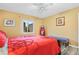 Charming bedroom with red bedding, a full-length mirror, and wood floors at 6321 Staunton Dr, Holiday, FL 34690