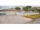 House exterior featuring a driveway, garage, and fenced yard at 6321 Staunton Dr, Holiday, FL 34690